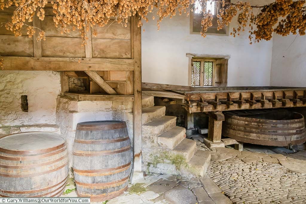 A couple of barrels in the brewhouse decorated with dried hops at lacock abbey in wiltshire