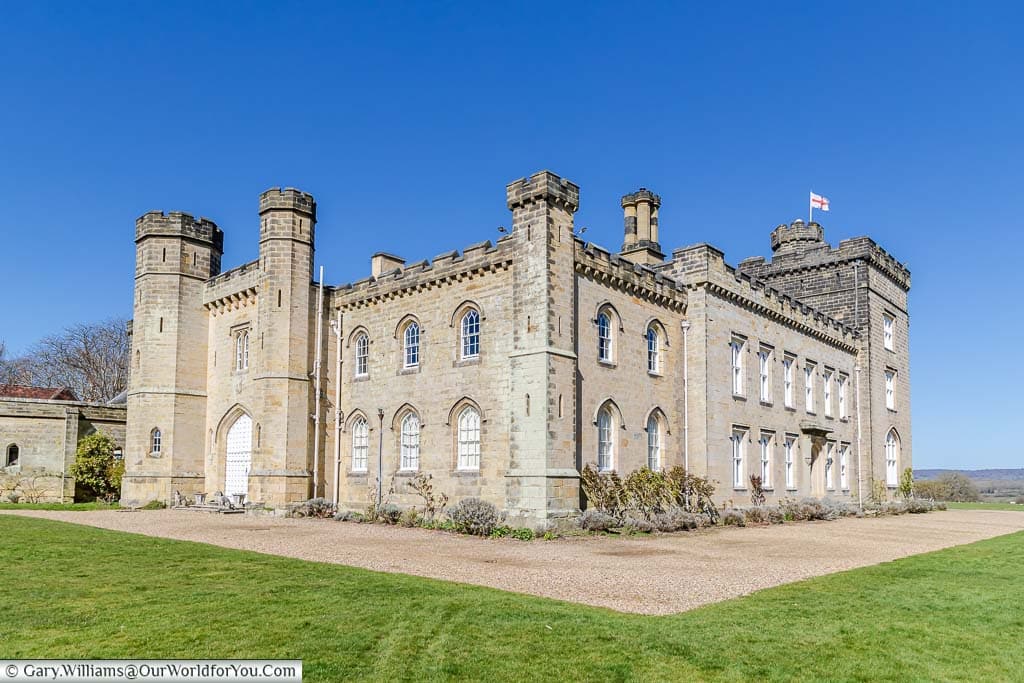 The 17th-century Chiddingstone Castle family home set in its own manicured grounds under a deep blue sky.