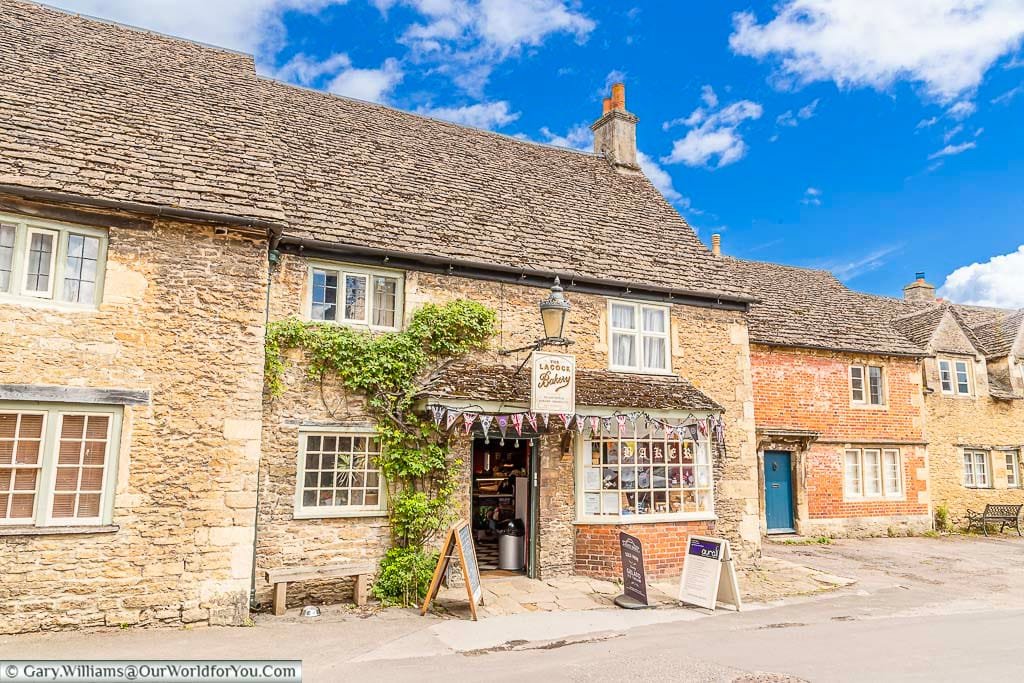 Bunting surrounds the traditional-looking Lacock Bakery in it's 15th-century rubble stone and stone slate roof building