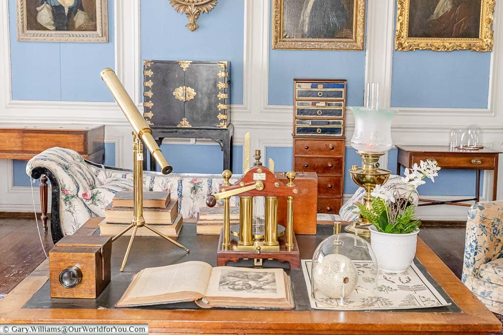 A traditional desk filled with late 19th-century scientific equipment in the blue parlour of Lacock Abbey in Wiltshire.