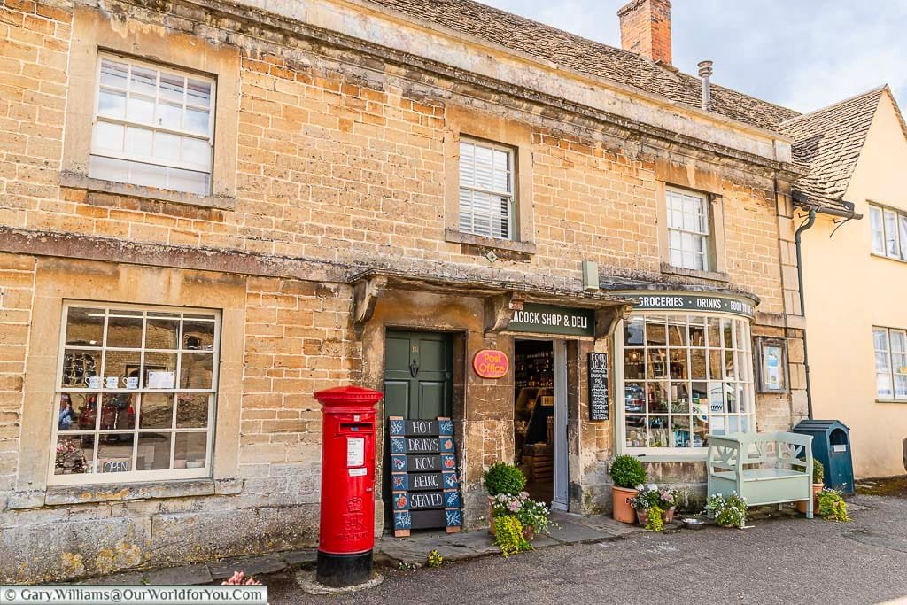 A red letter box outside the old post office in Lacock village