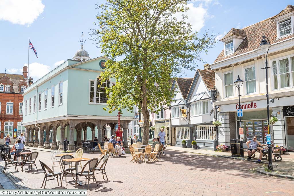 A view of Faversham Guildhall from Court Street) with tables & chairs outside cafe's on a bright sunny day. Historic Market Town in Kent
