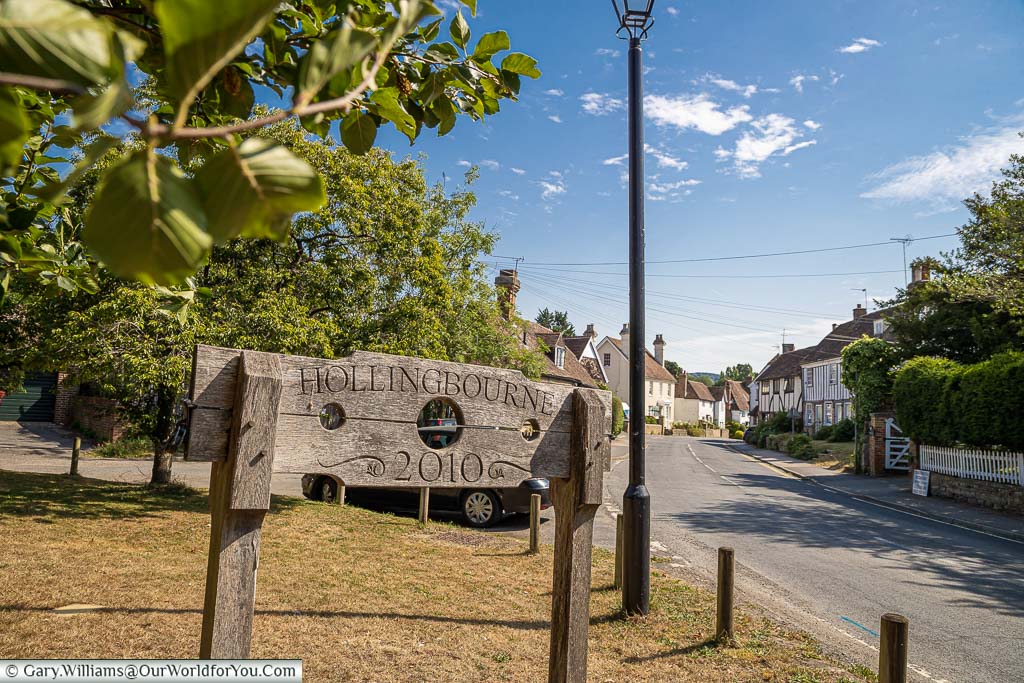 The village sign for Hollingbourne etched on a pillory, commissioned in 2010