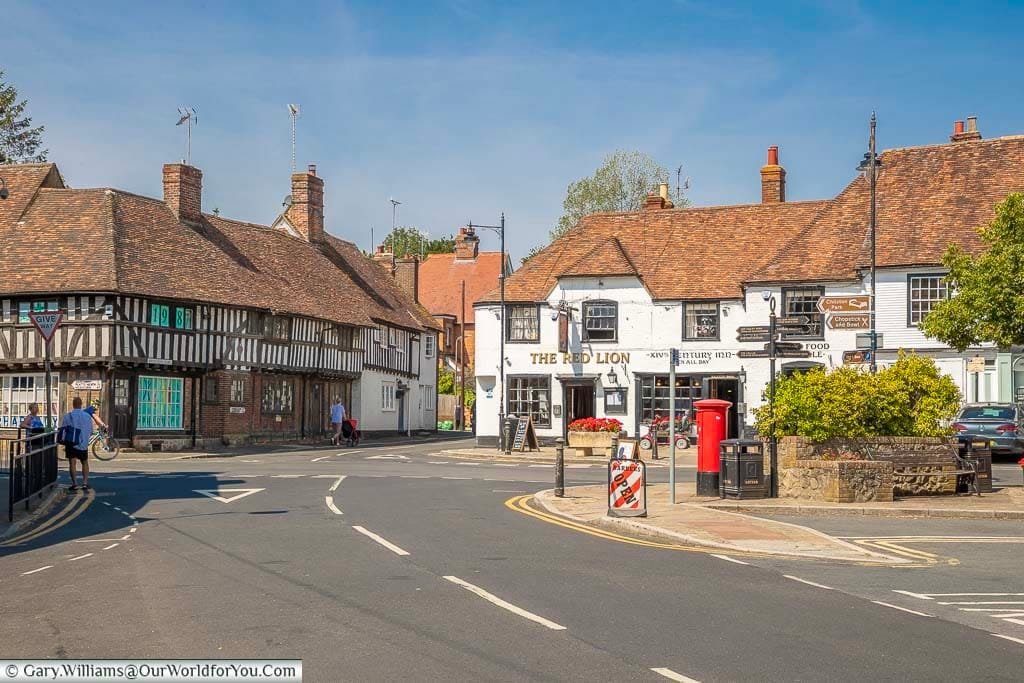 The crossroads at Lenham village square in Kent featuring historic buildings including the Red Lion pub