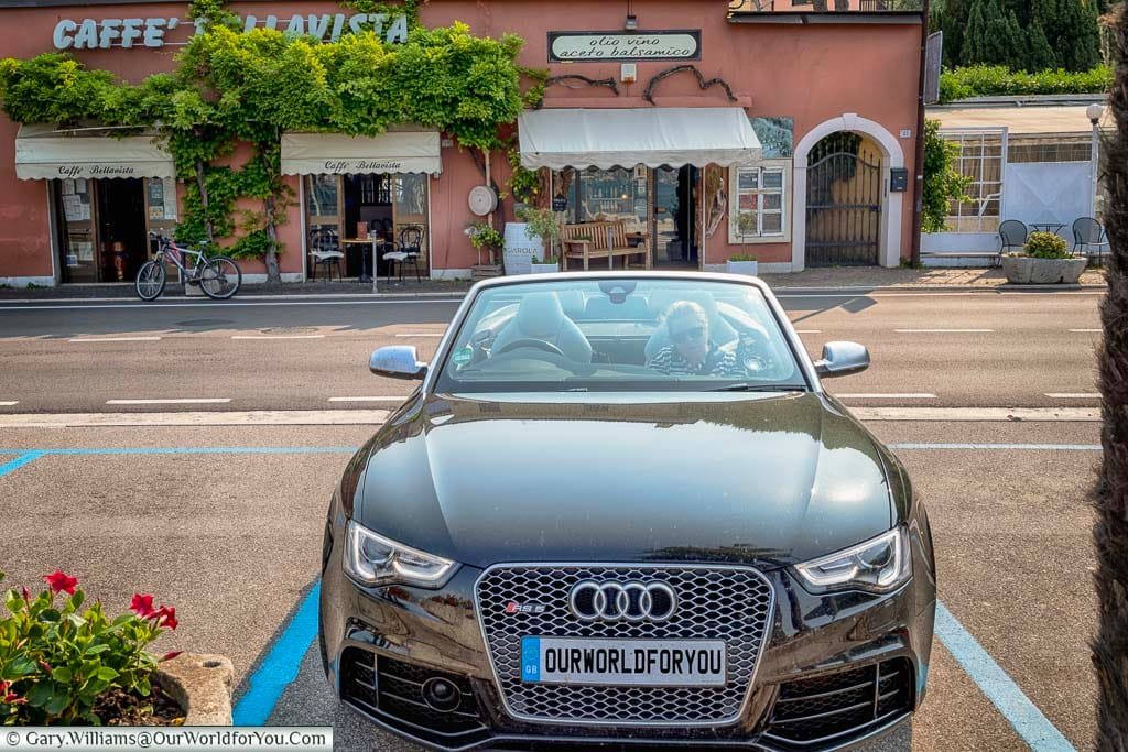 Our car parked up in front of a cafe on the edge of Lake Garda.