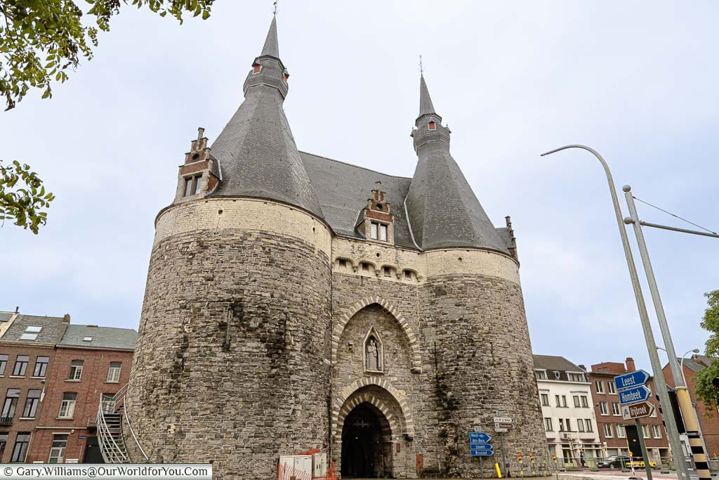 The twin towers with their tiled conical roofs of medieval Brusselpoort city gate of Mechelen from the 13th century.