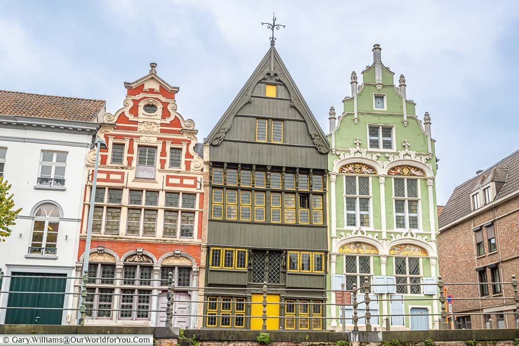 Three historic guild buildings on the river's edge in Mechelen