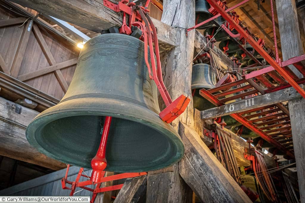 The verdigris bronze bells of Saint Rumbold’s Cathedral in Mechelen, with the contrasting red mechnisms to strike them.