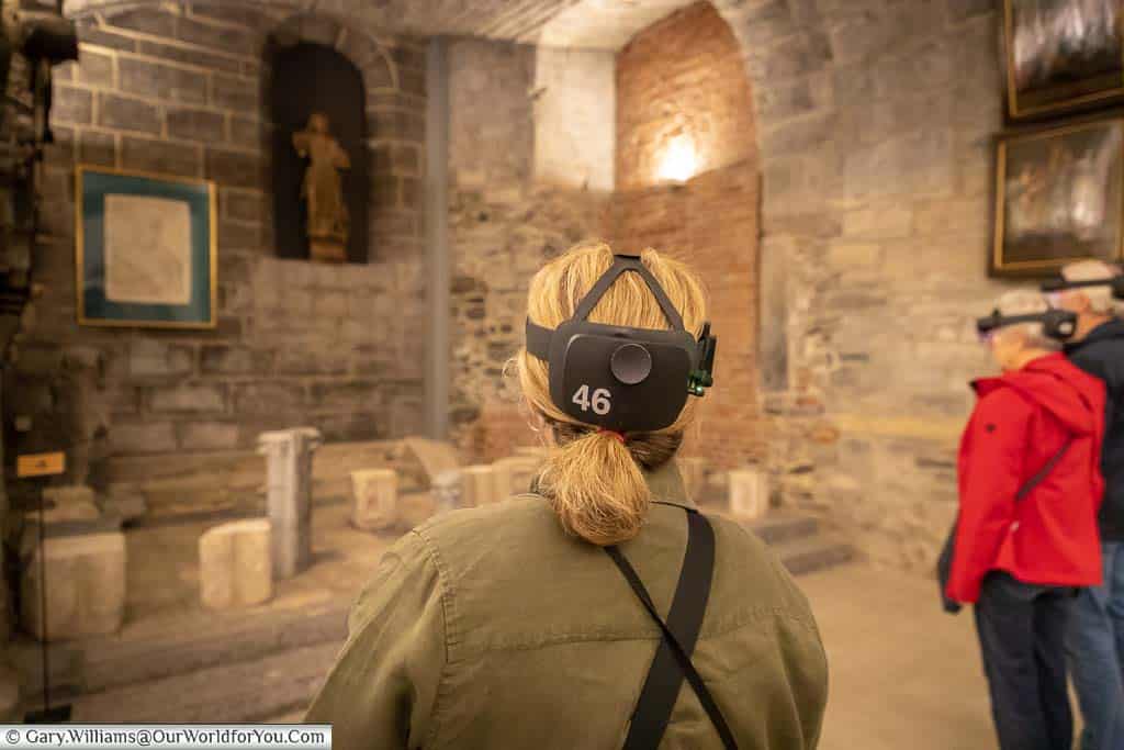 The back of Janis wearing her AR headset while experiencing the tour of the Mystic Lamb in St Bavo’s Cathedral, Ghent.