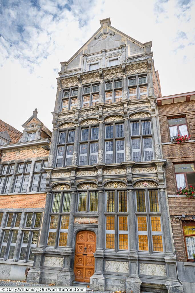 The tall historic guild of fishmongers building on the river's edge in Mechelen