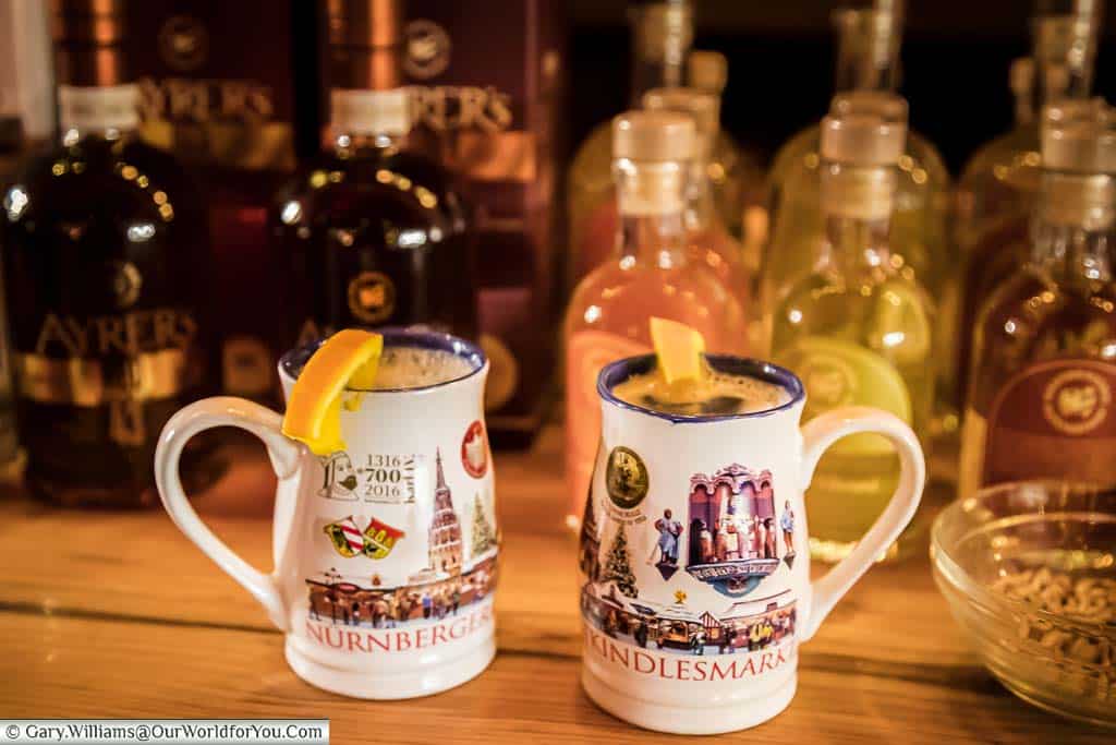Two Nuremberg's Winter Warmers in decorative mugs on a stall on the Christmas Markets