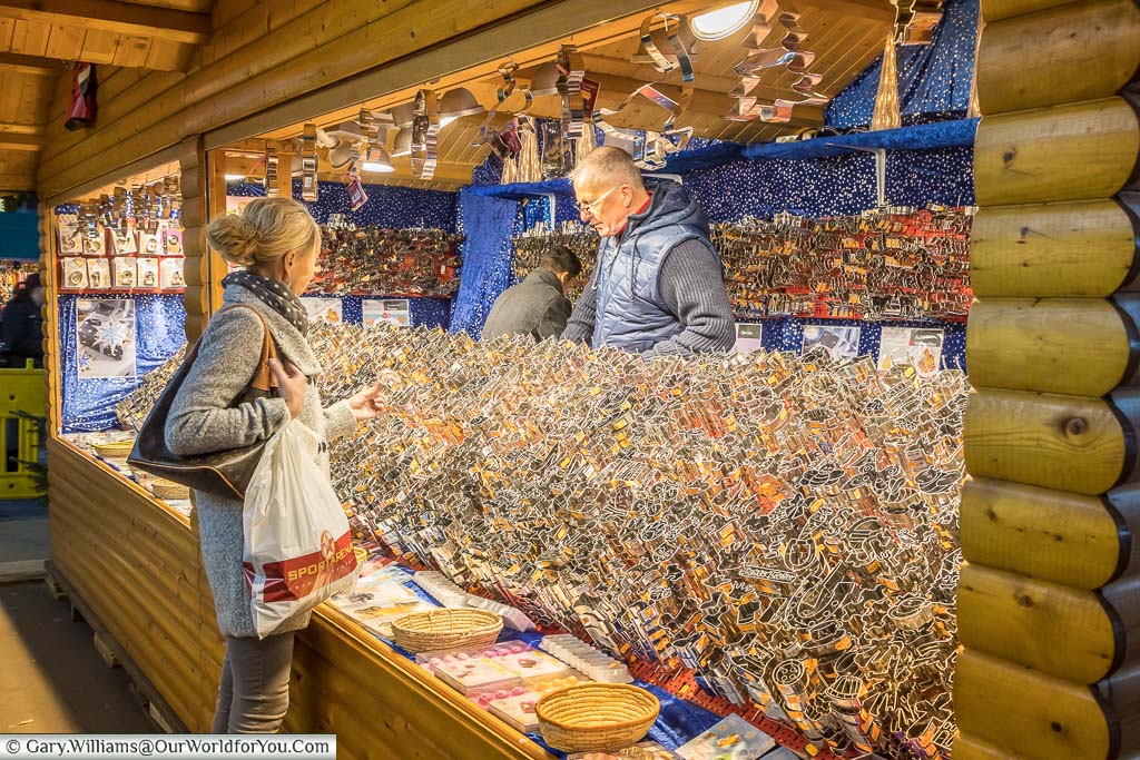 A lady perusing hundreds of different gingerbread cutters on a Christmas Market stall in düsseldorf, germany