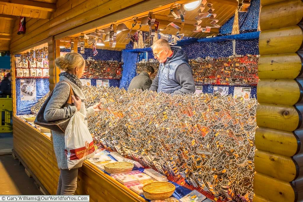 A lady perusing hundreds of different gingerbread cutters on a Christmas Market stall in düsseldorf, germany