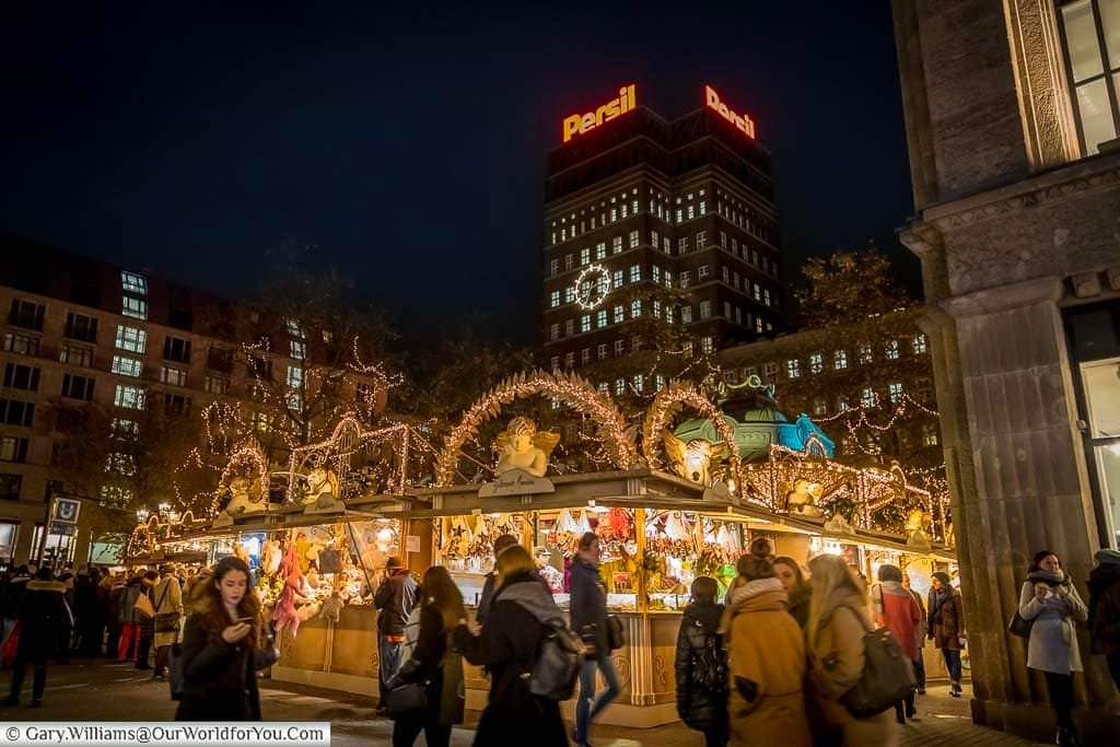 The angel christmas market at night in front of the persil tower block in centre of düsseldorf, germany