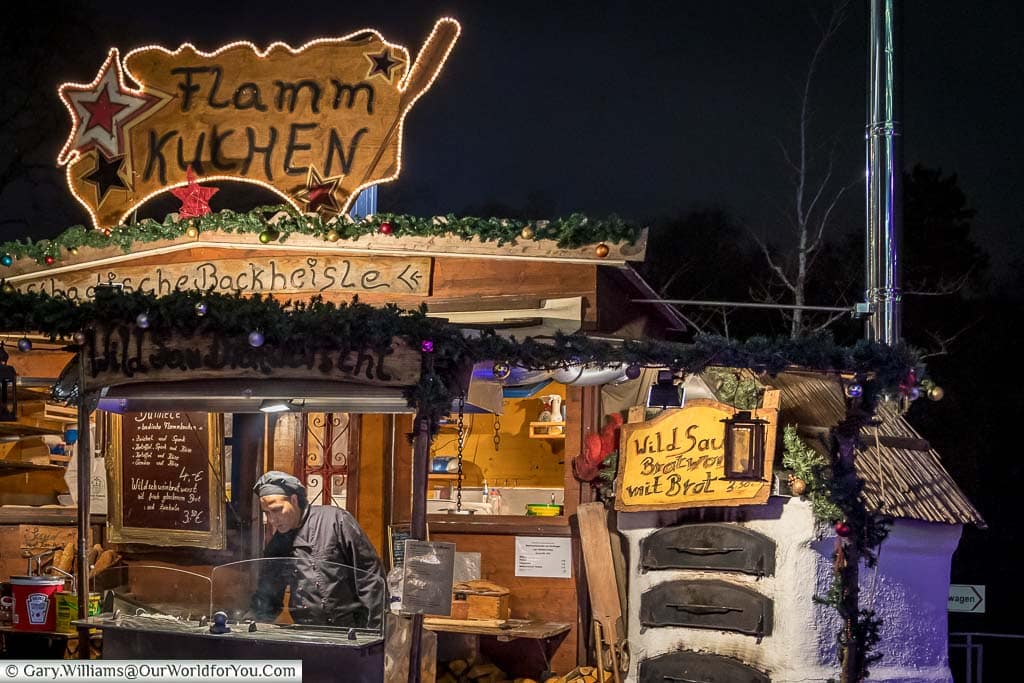 A food stall in düsseldorf's Christmas markets selling pizza-like flamm kuchen
