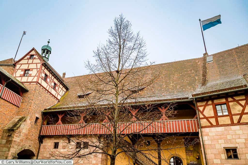 Looking up at the frosted gabled sections of nuremberg castle during its german christmas market season