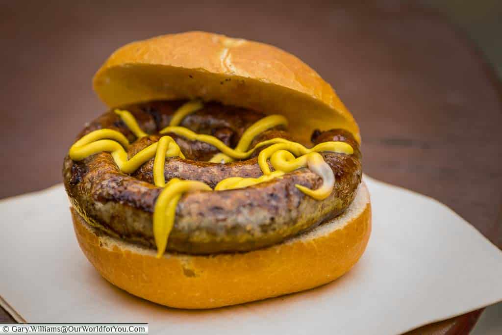 A rolled sausage, with a good drizzle of german mustard, in a bun at Rothenburg ob der Tauber's Germany Christmas Market