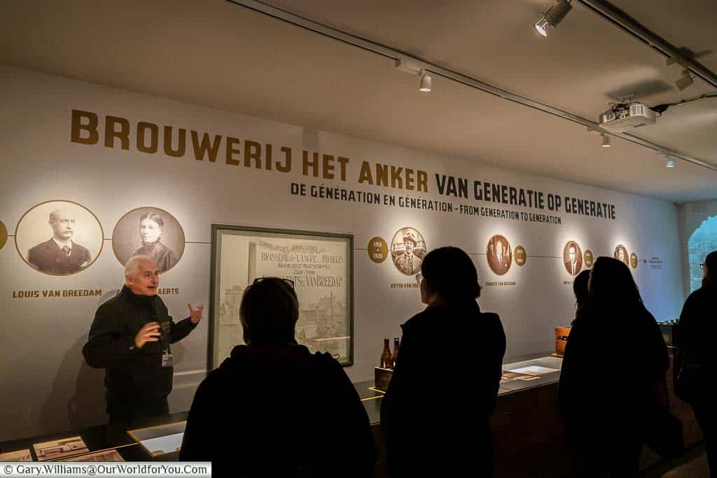 Our guide for the het anker brewery tour, Rudy, explains the history of the het anker brewery in front of a timeline of events.