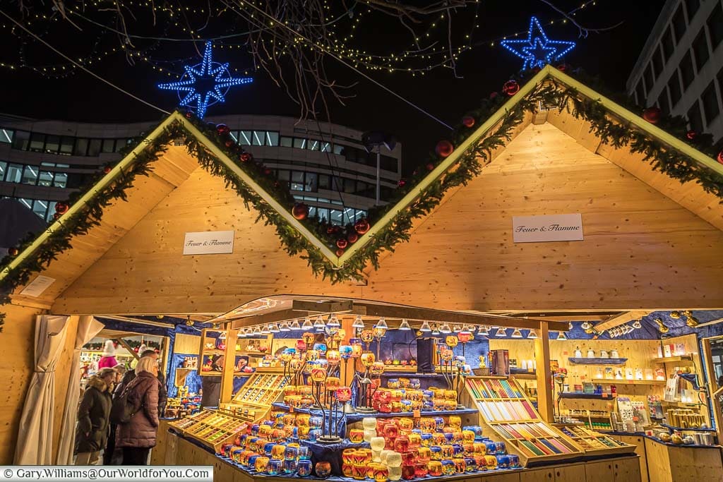 A double-width christmas market cabin specialising in candles in düsseldorf, germany