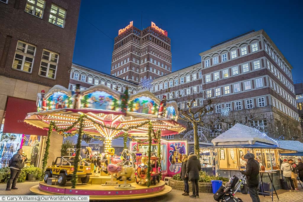 A miniature carousel on the edge of the german christmas market in stadtbrückchen square, düsseldorf, germany