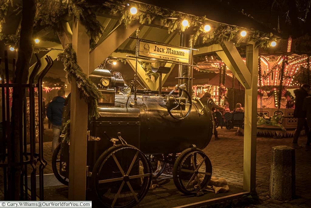 A chestnut roaster in the shape of a miniature steam locomotive in a christmas market in rothenburg ob der tauber.