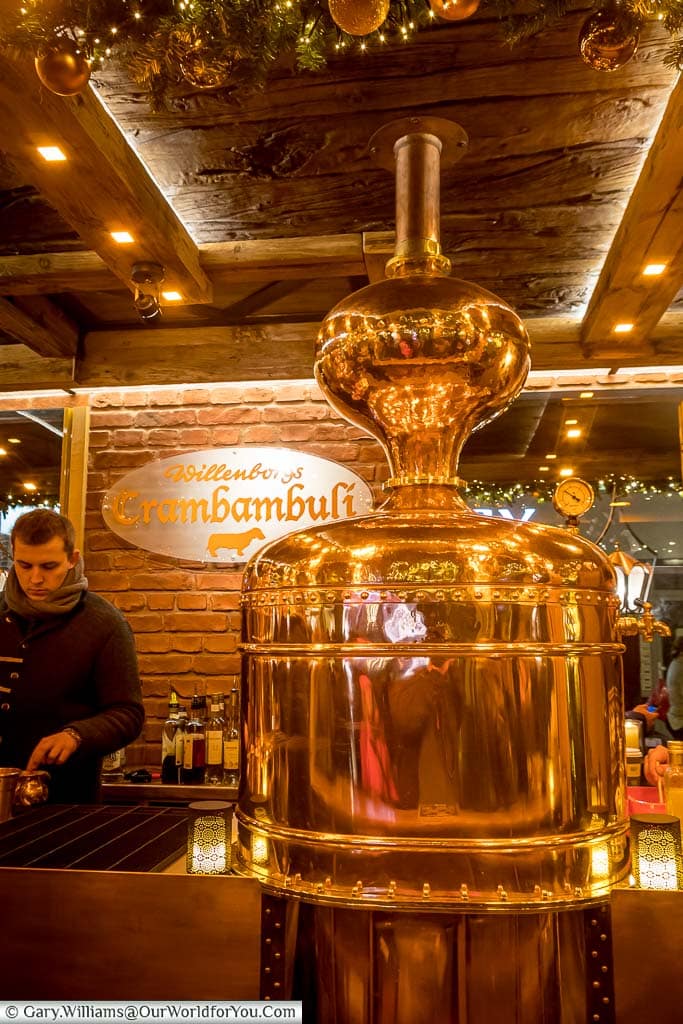 A highly polished copper still is the centrepiece of a drink stall at the Christmas market in Kaufingerstraße.