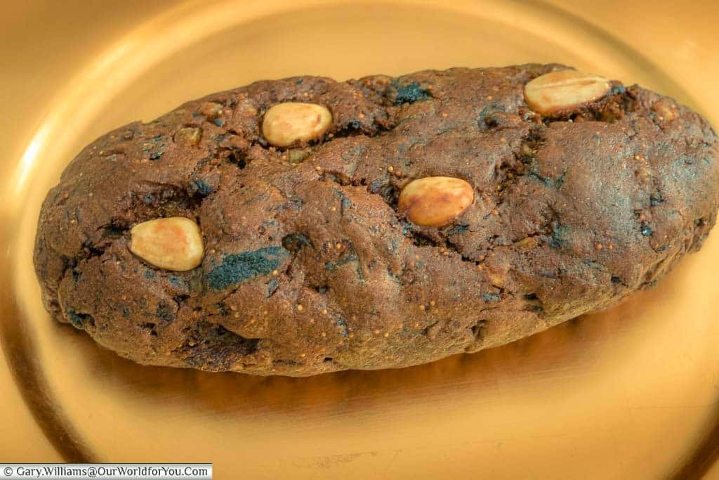 A whole gingerbread loaf purchased from the nuremberg christmas markets in germany, presented on a golden platter.