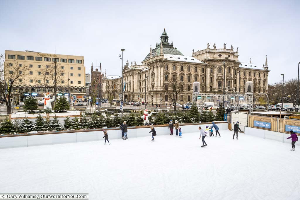 A group of skaters take to the ice at the Christmas Market at Karlsplatz on a grey day in Munich.