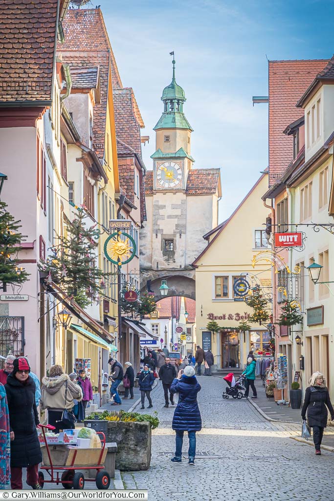 A cobbled lane leading to a gatehouse tower in rothenburg ob der tauber at christmas