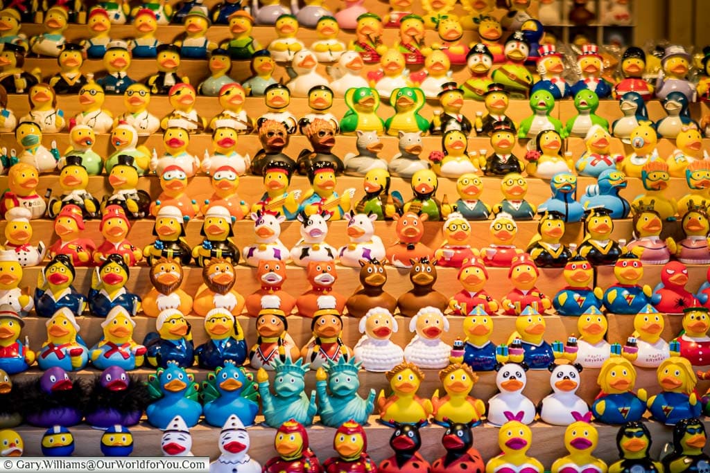Hundreds of pairs of little rubber ducks on a christmas market stall in dusseldorf, each pair featuring the duck in different costumes