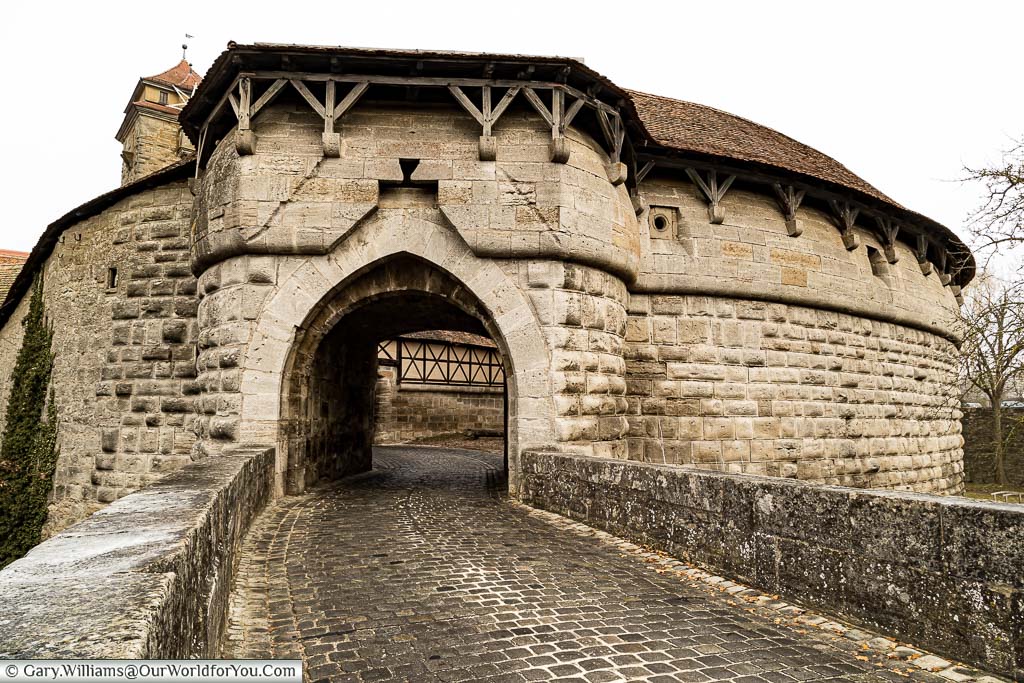 The cobbled road leading through the spital gate at the southern end of rothenburg ob der tauber