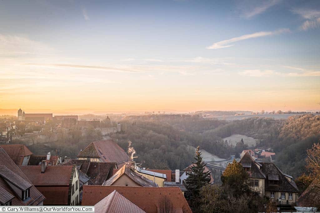 The sunset over the landscape around rothenburg ob der tauber on a winter's eve.