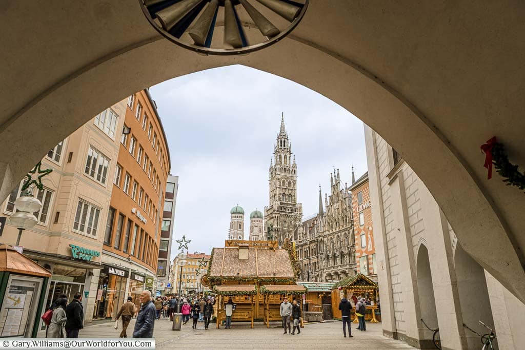 Looking through the arch of the old Rathaus towards the Christmas market in front of the new Rathaus, with the twin towers of the cities Cathedral.