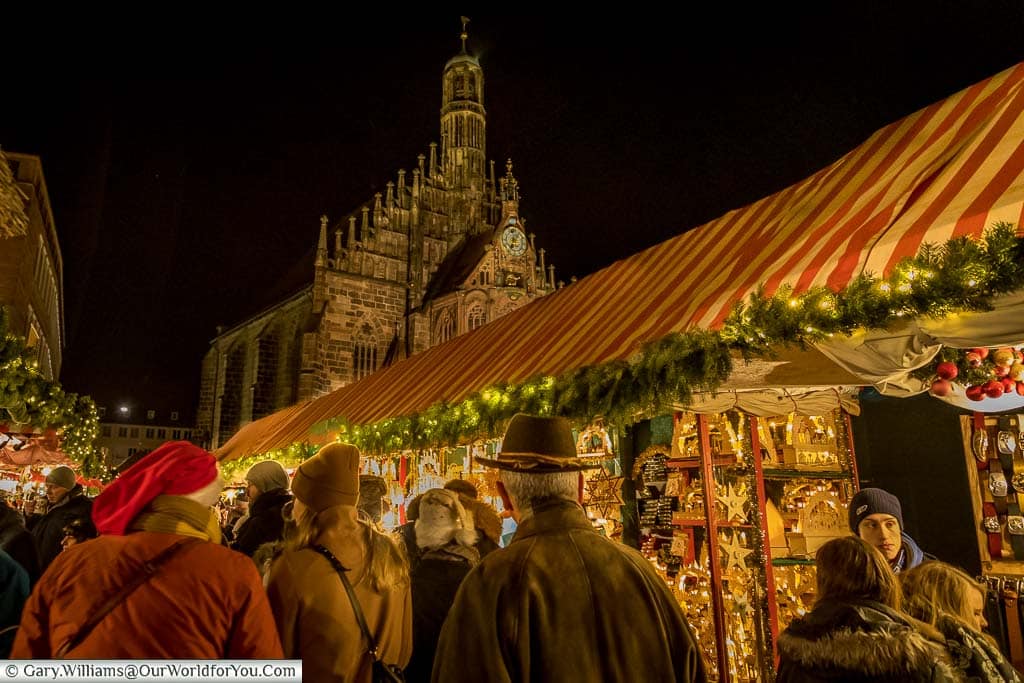We are following the crowds through Nuremberg's main market, with the illuminated church in the background.