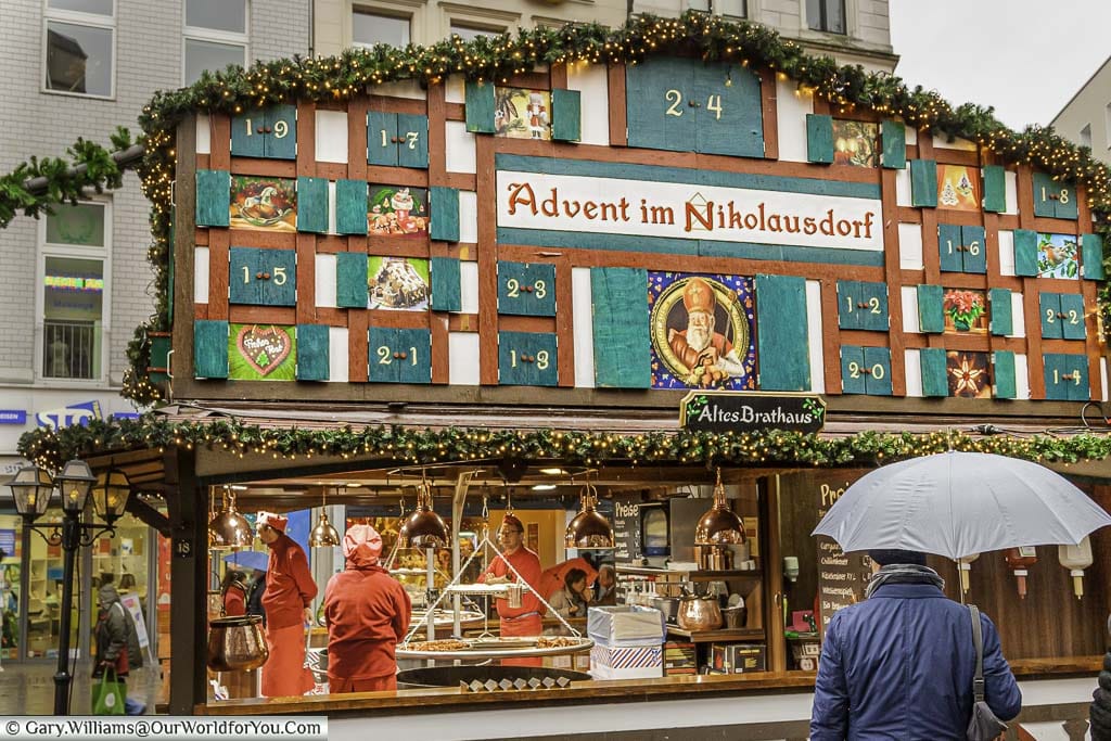 An advent calendar in the gable end of the roof of a sausage stall in the Nikolausdorf christmas market in cologne, germany