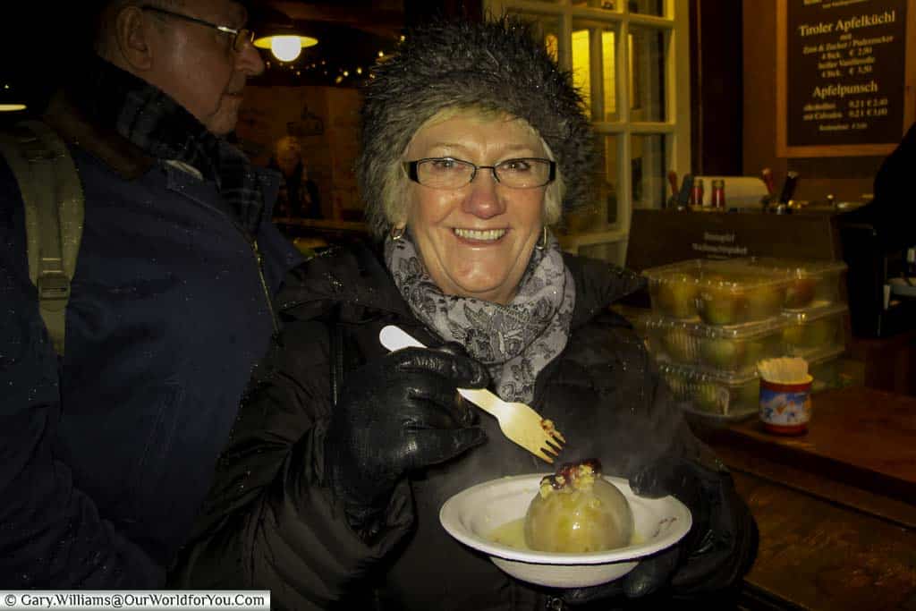 Barbara, Janis’s Mum, tucking into a baked apple on the Christmas markets in Cologne.