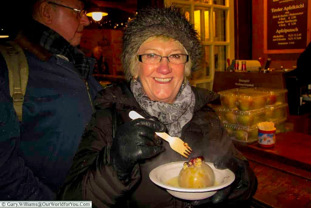 Barbara, Janis’s Mum, tucking into a baked apple on the Christmas markets in Cologne.