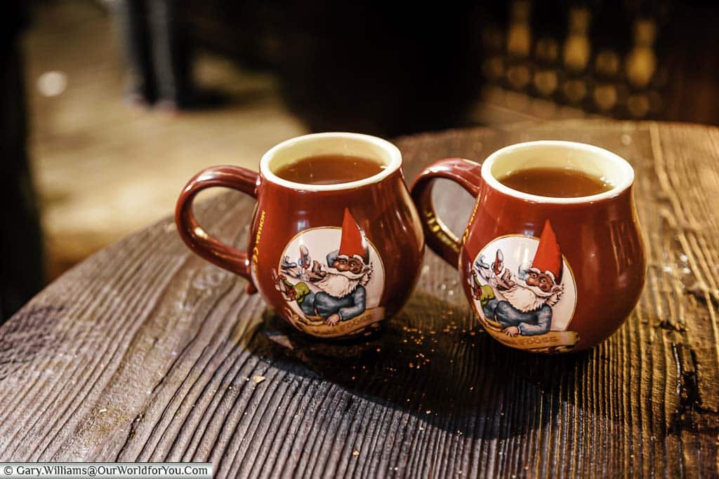 Two mugs of steaming glühwein in beautiful souvenir mugs at the Christmas Markets in Cologne, Germany