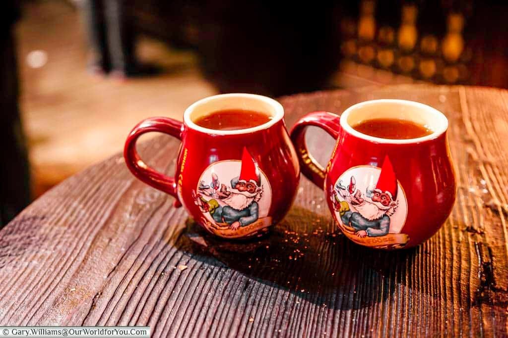 Two glasses of steaming Gluhwein in the souvenir mugs at the Christmas Markets in Cologne, Germany