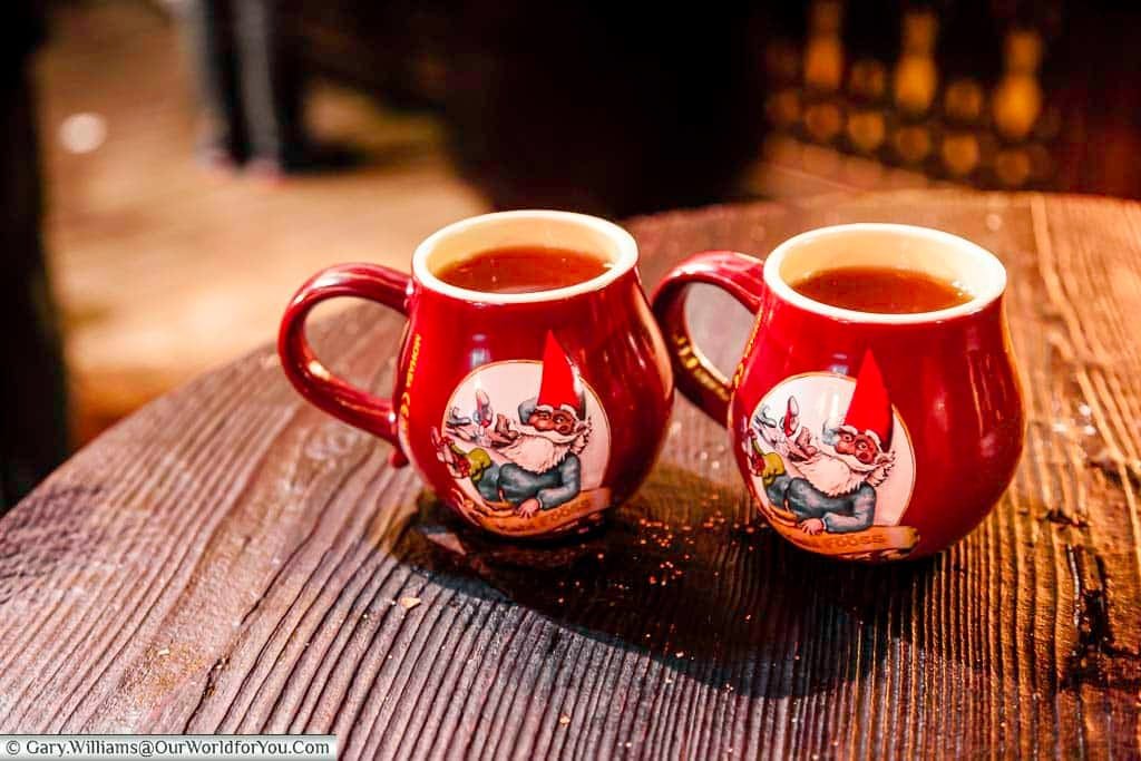 Two mugs of steaming glühwein in beautiful souvenir mugs at the Christmas Markets in Cologne, Germany