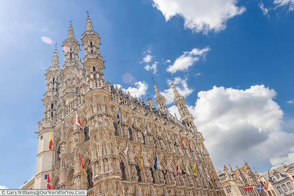 Leuven's historic City hall with its ornate facade on a bright day