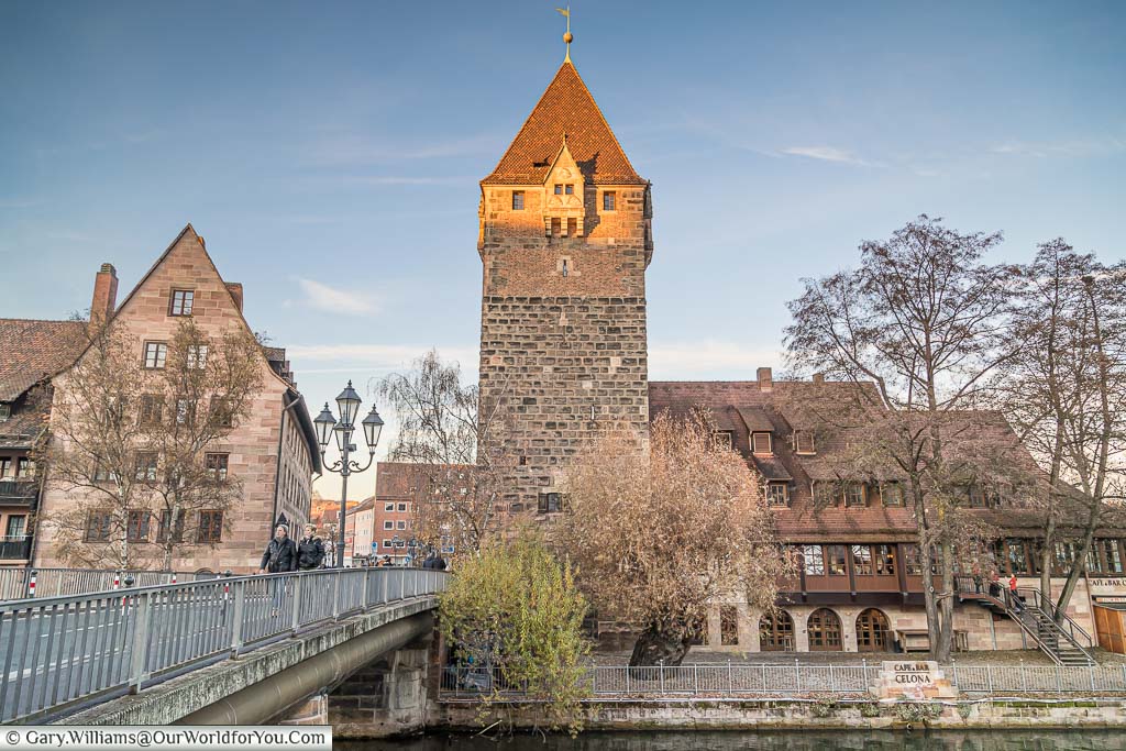 The view of one of Nuremberg's historic towers, the Schuldturm Tower, or debt tower from across the River Pegniz, next to the Heubrücke bridge.