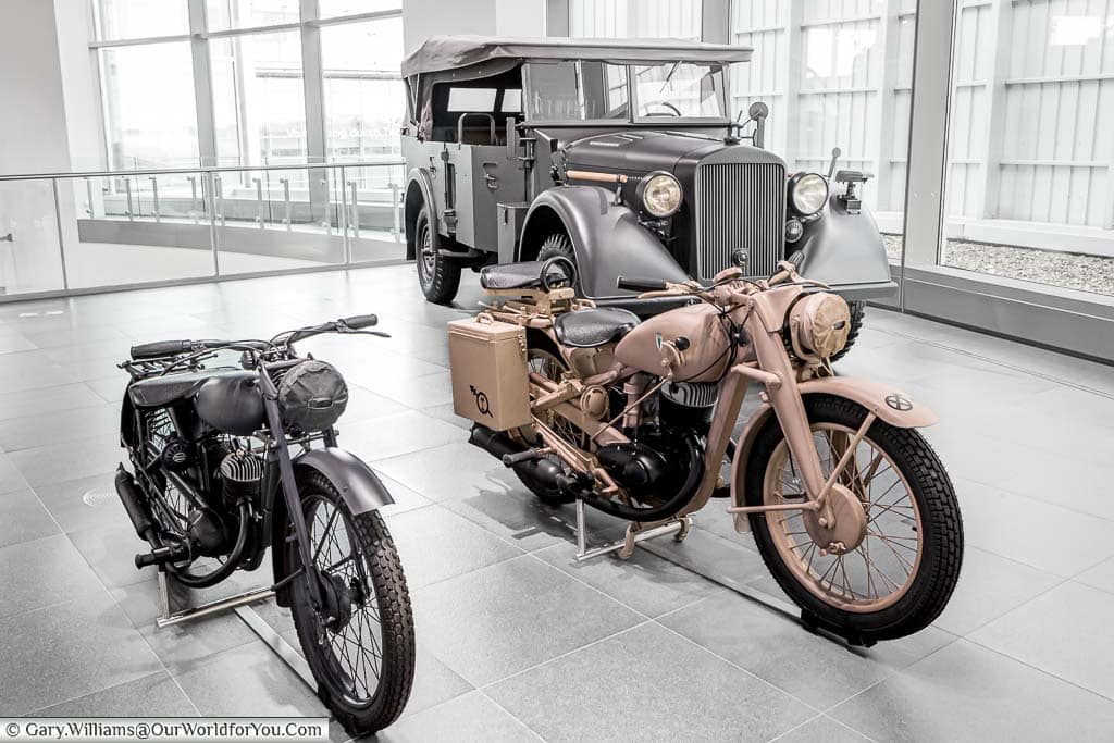 Two military motorbikes and a truck represent the brand's involvement in the Nazi war effort.