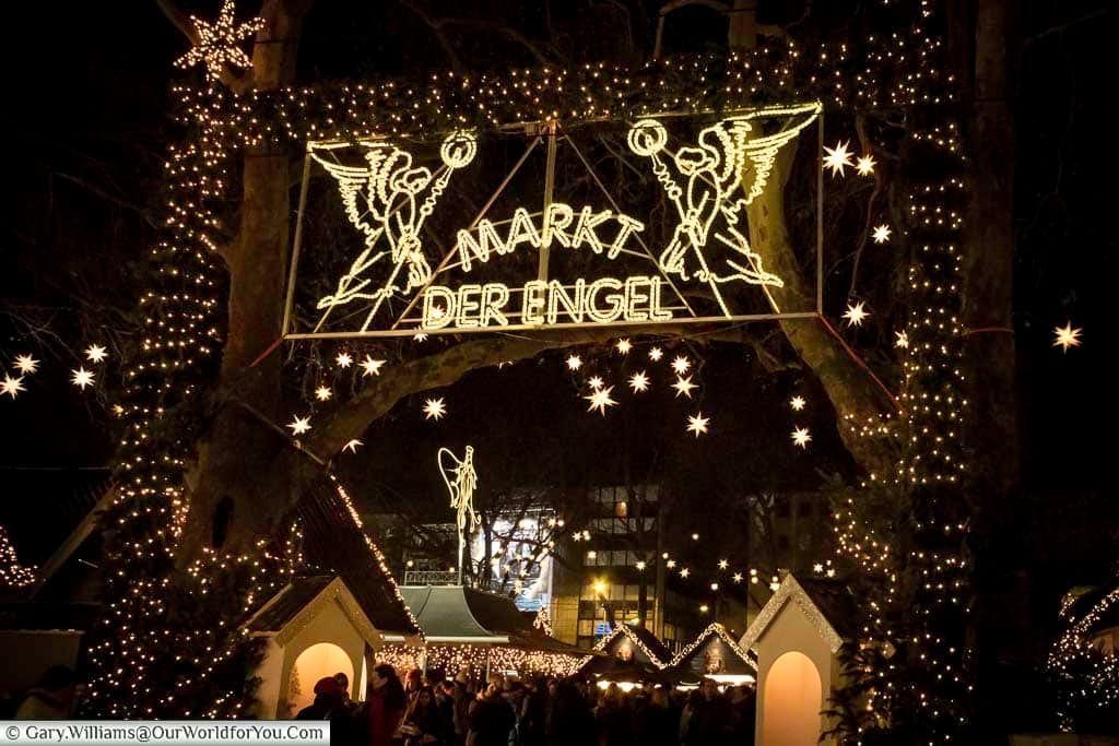 One of the illuminated entrances to Cologne's Angel Christmas market at night