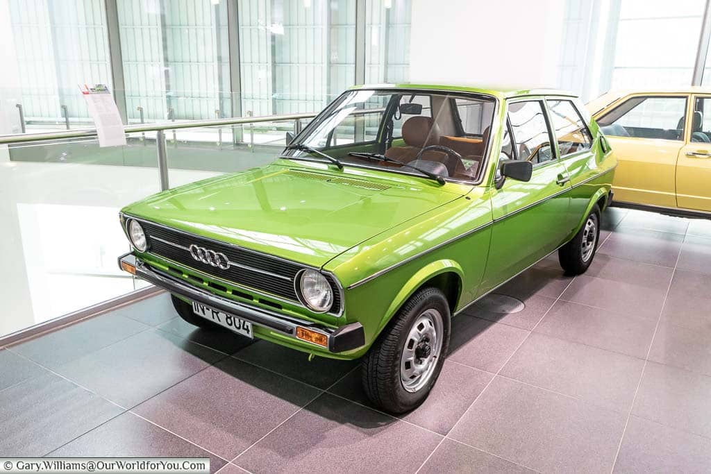 An apple green Audi 50 that bears a close resemblance to an 1970's Volkswagen Polo in the audi museum in ingolstadt, germany