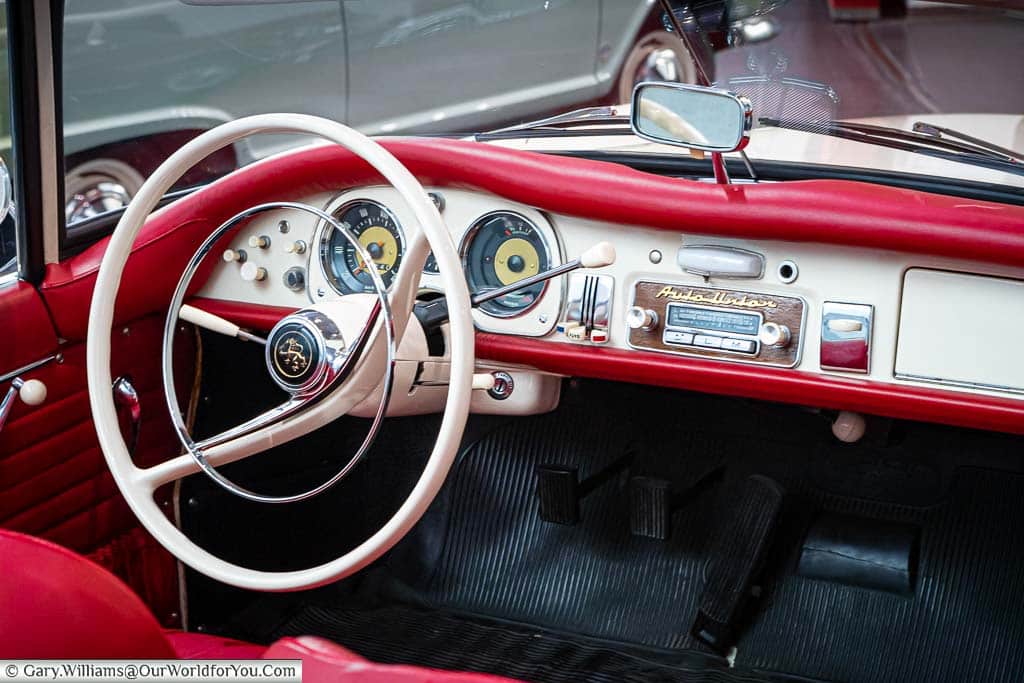 the 1950's minimalist interior of the Auto Union 1000 SP in cherry red and cream in the audi motor museum