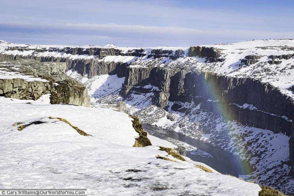 A rainbow over the gorge and river running through it that flows between the Dettifoss & Selfoss waterfalls in Iceland.