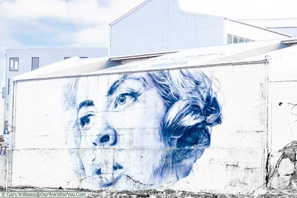 A beautiful black and white portrait of a woman on a disused building in Reykjavik, Iceland.