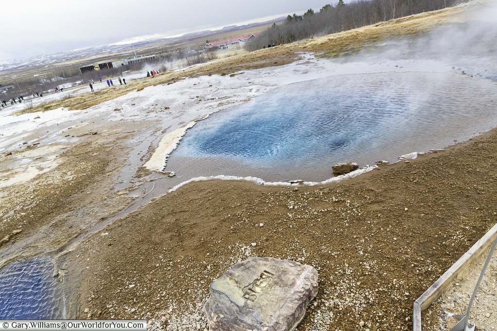 Ripple across two deep crystal clear pools of heater water in the Haukadalur geothermal area of Iceland's Golden Circle