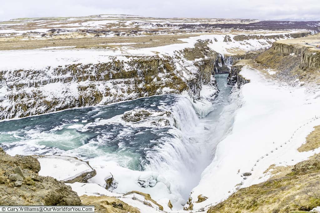 A view of the blue waters falling into the gorge that forms the Gullfoss waterfall